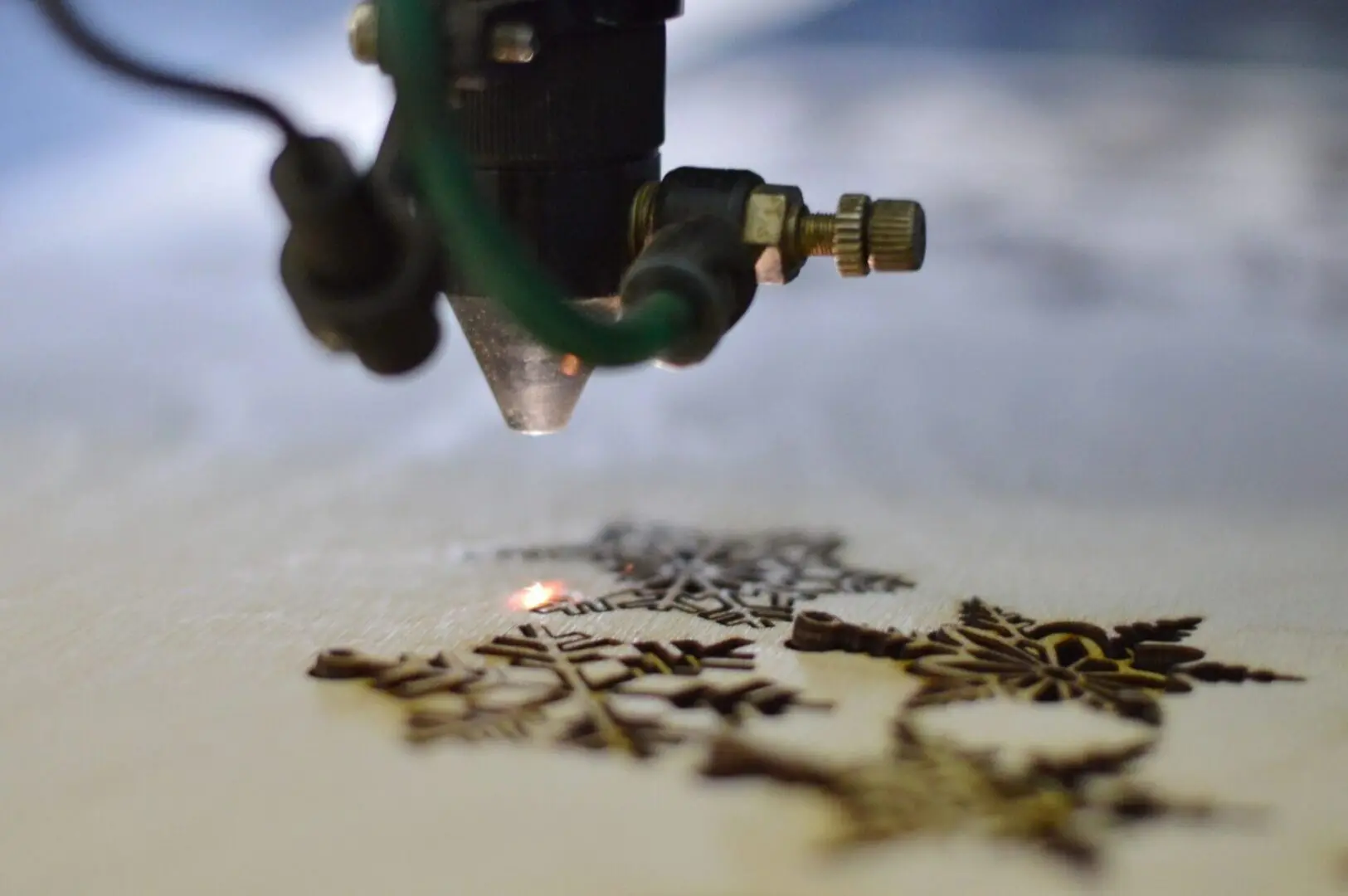 A closeup look at a laser machine cutting shapes