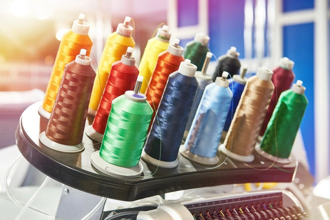 A rack of spools of thread in various colors.